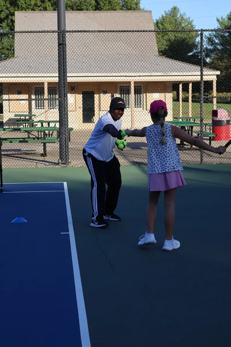 Coach Kuda encouraging a junior player during a drill